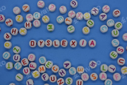 Preview: Dyslexia, n red letters, surrounded by random alphabet letters on a blue background with copy space