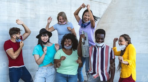 Preview: Happy friends wearing face mask listening music with vintage boombox outdoor