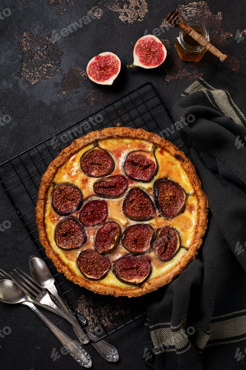 Preview: Homemade quiche tart with figs, cream cheese and honey on dark brown background. Vintage style. Top