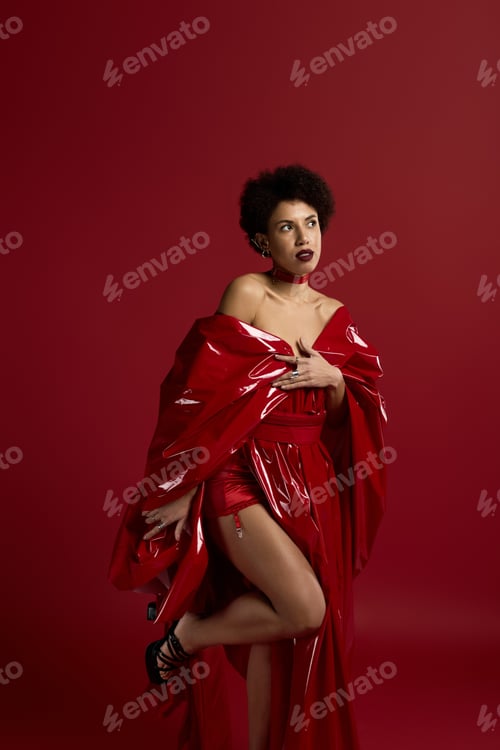 Preview: Stunning woman in vibrant red attire showcasing fashionable elegance in a creative setting