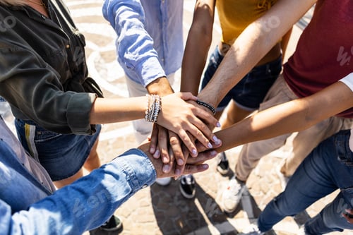 Preview: High angle view of multiracial friends stacking hands