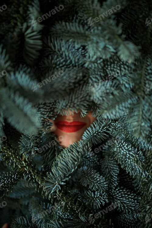 Preview: Women's face covered with nobilis branches