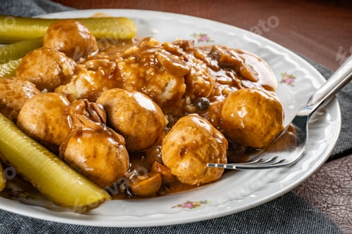 Preview: Chicken meatballs and mushrooms gravy served with groats bulgur and pickled cucumber.
