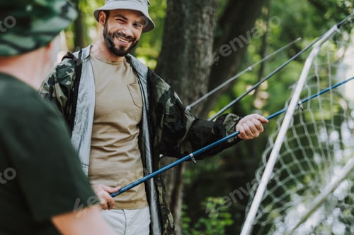 Preview: Waist Up Of A Cheerful Handsome Man Holding Net While Enjoying Fishing With His Father