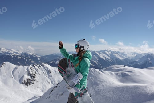 Preview: Snowboarder taking in the mountain view before descent