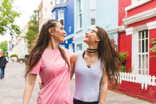 Preview: Two happy teenage girls on the go in the city