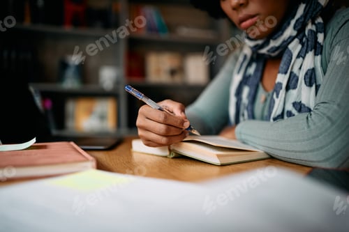 Preview: Close-up of African American female student learning in a library,