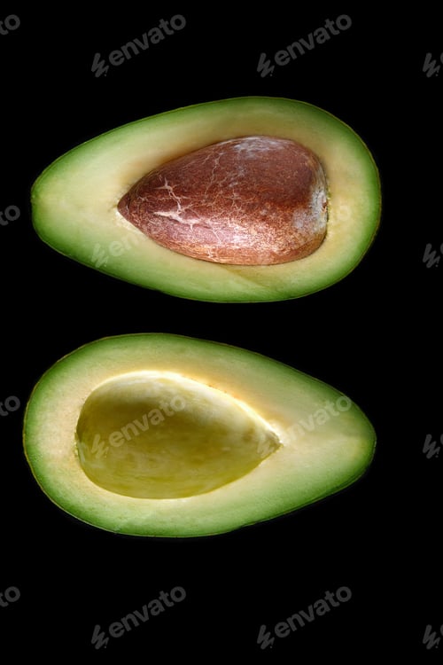 Preview: Macro shot of fresh avocados cut in a half on the black background
