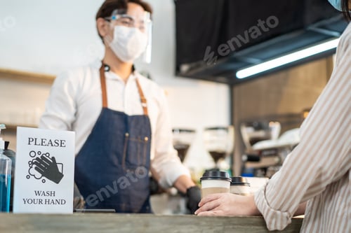 Preview: Close up of Please wash your hand Sign on counter bar in coffeehouse during Covid 19 pandemic.