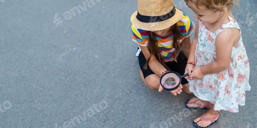 Preview: The child is playing with the frog. Selective focus.