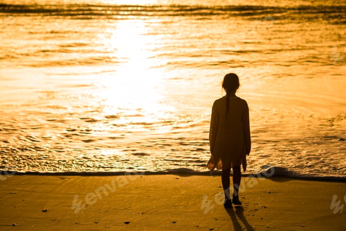 Preview: Adorable happy little girl walking on white beach at sunset