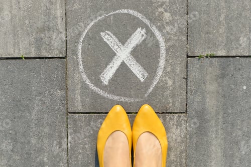 Preview: Checkmark no sign on gray sidewalk with woman legs, top view