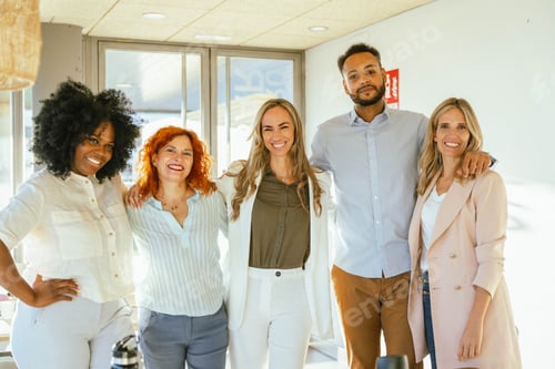 Preview: Group of diverse business people smiling while standing together in the office.