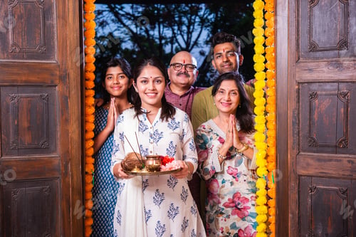 Preview: Gruhapravesh - indian asian family in traditional wear entering new home