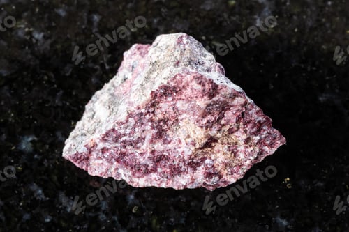 Preview: sample of raw piemontite rock on black granite
