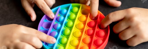 Preview: kids anti stress sensory pop it or simple dimple fidget push toys in kid's hands. playing with a toy