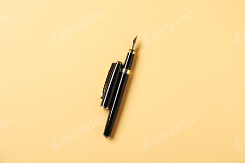 Preview: One fountain pen and lid on yellow background, top view
