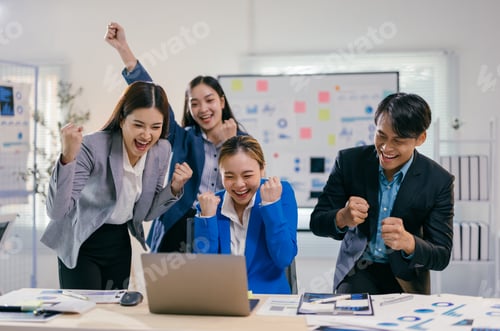 Preview: Team of young professionals is cheering and raising their arms in front of a laptop, excited about t