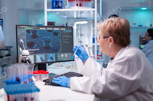 Preview: Professional doctor scientist looking in computer for medical experiment