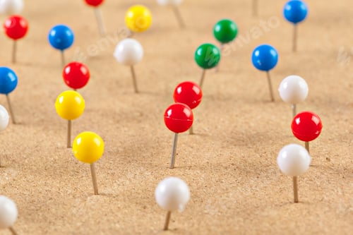 Preview: Group of thumbtacks pinned on corkboard
