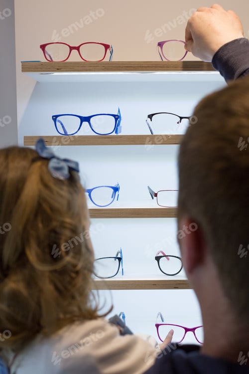 Preview: Young girl trying on glasses