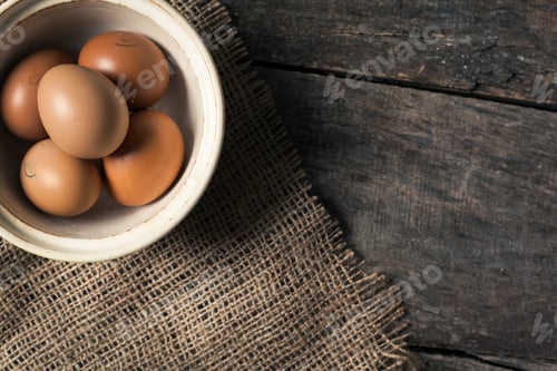 Preview: eggs in a bowl on the table from the old boards