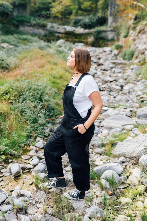 Preview: Woman standing in dry riverbed, Rezzago, Lombardy, Italy