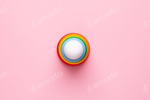 Preview: Colorful children's wooden pyramid on a pink background, toy for toddlers and babies