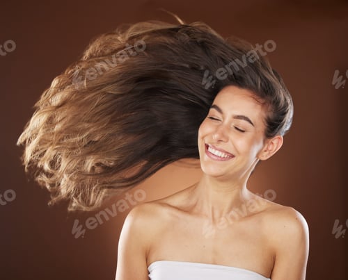 Preview: Hair, beauty and skincare with a model woman in studio on a brown background for natural or keratin