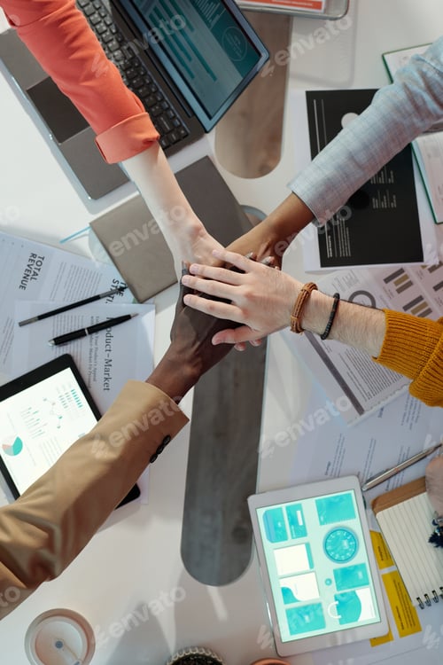 Preview: Team Members Stacking Hands in Collaborative Office Meeting