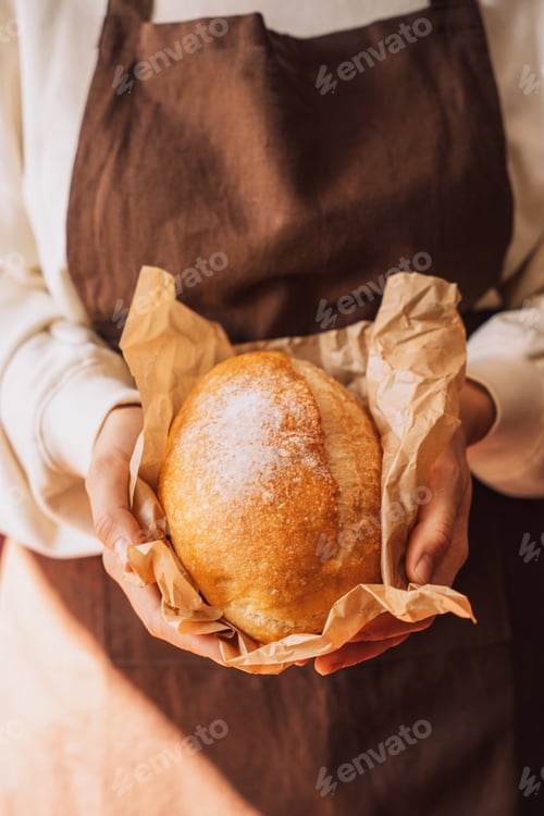 Preview: Fresh loaf of bread with ears of wheat and pumpkin on a wooden table