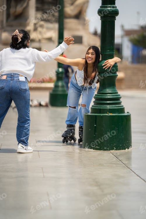 Preview: Young woman learning to roller skate with friend in city park