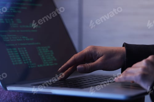 Preview: Close up of computer hacker stealing data from laptop.