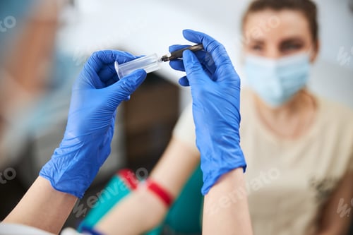 Preview: Phlebotomist assembling the syringe prior to blood collection