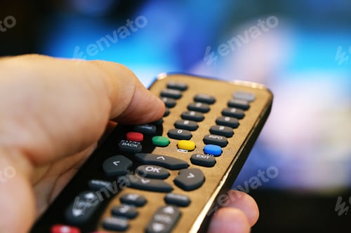 Preview: People hand using television remote control blur background