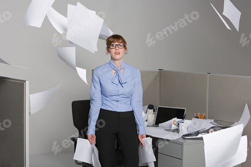 Preview: Businesswoman throwing paper into the air