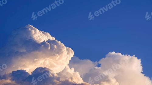 Preview: white cumulonimbus clouds with light reflection on surface in dark blue sky background