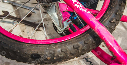 Preview: A father repairs his daughter's bike.