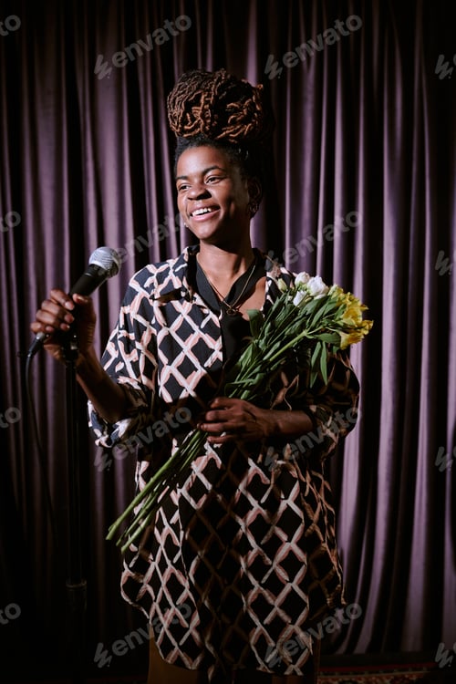 Preview: Smiling Woman Holding Microphone and Bouquet of Flowers