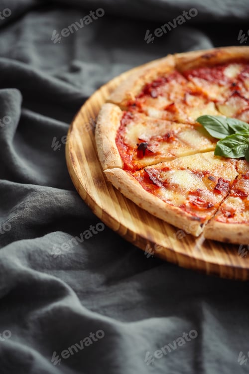 Preview: Delicious Pizza with Basil on a Wooden Plate