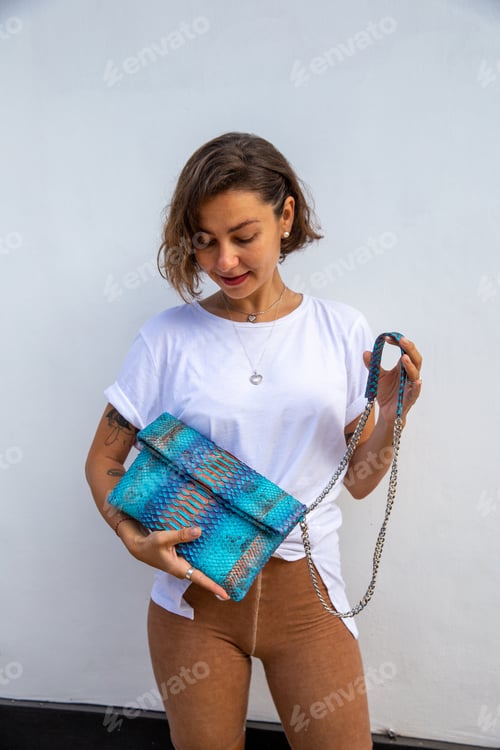 Preview: Beauriful woman in white tshirt and casual cloths with blue python bag