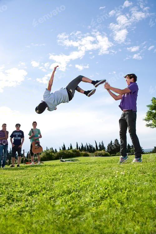 Preview: Teen boys help friend to do a flip