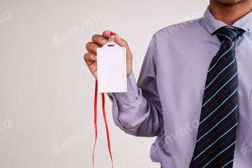 Preview: Businessman Holding Blank White ID Card With Red Lanyard