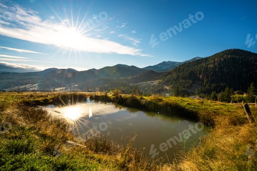 Preview: A small beautiful forest clearing for hiking, bathed in warm sunlight on the unusual hills of the