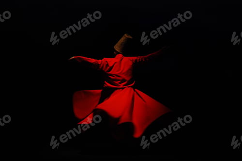 Preview: Person in a red dervish costume spinning on a black background