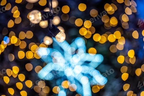 Preview: Outdoor decorated Christmas tree with light garland, selective focus