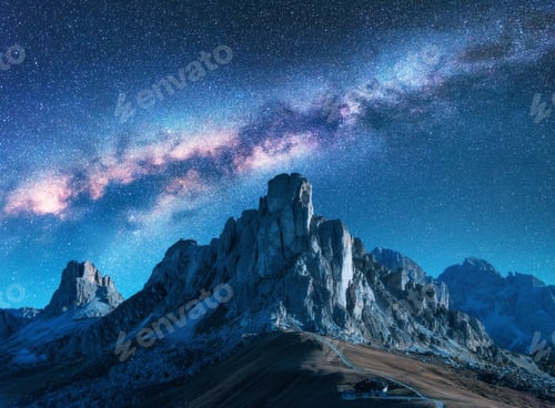 Preview: Starry sky with Milky Way above mountains at night in summer.