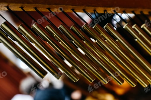 Preview: Musical detail of a golden Windchimes.