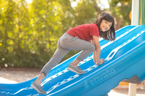 Preview: Cute little girl having fun on a playground outdoors in summer