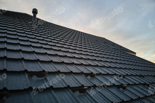 Preview: Snow guard for safety in winter on house roof top covered with steel shingles. Tiled covering of